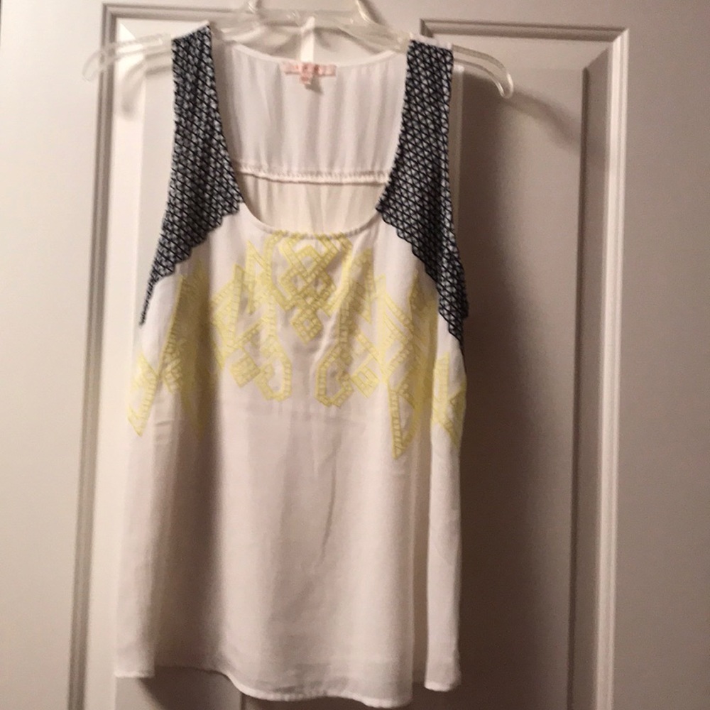 Sleeveless white top with embroidery